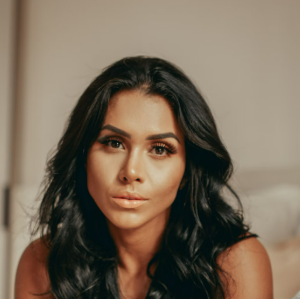 Woman with long black hair posing indoors
